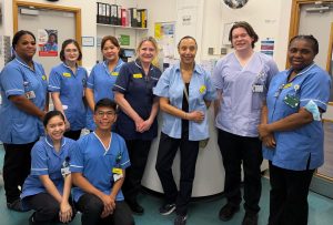 A group of nursing staff are gathered together on a ward