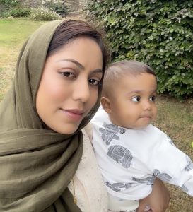 Sammiya stands in a garden, holding Yasin